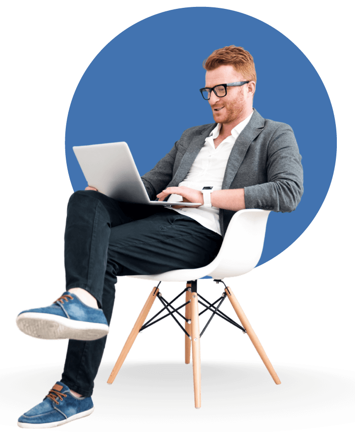 a guy sitting and using laptop
